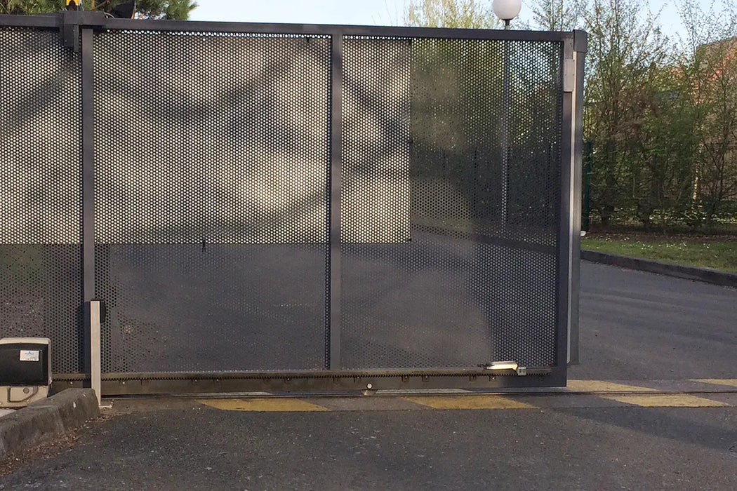 Sliding gate installation showing the bottom rollers with bolt ref 363, top guide roller plate  and gate motor with photo cells.